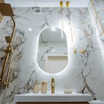 the bathroom features essential elements including a stylish sink, a wellplaced mirror, and an overhead shower head, creating a functional yet aesthetically pleasing space